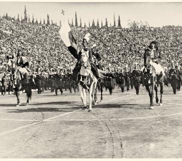 Historical  re-enactment with Alexandros Ypsilantis leading the Sacred Band. From the Centenary celebrations for the Greek Revolution, organised by the Lykeion ton Ellinidon at the Athens Stadium, 6 April 1930. Gelatin silver print by Dimitris Giangoglou.  Photographic Archive of the National Historical Museum, catalogue number 243